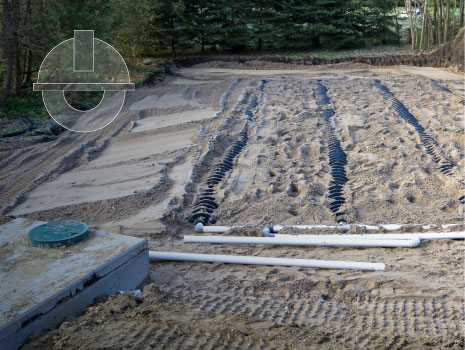 Construction site view of a septic tank and raised bed sand filled weeping bed.