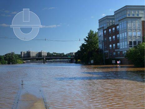 The flooded roadways and highways of the City of New Brunswick, NJ after flooding from hurricane Ida. Image has and gradient overlay with engineering icon.