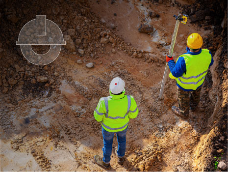 View from above of Surveyors at a construction site. Examining site.