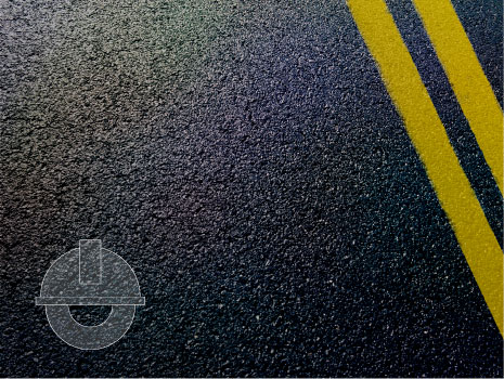 Asphalt detail of road with engineering icon in bottom left corner of image