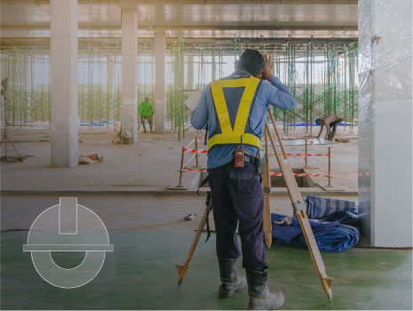 Surveyor engineer worker making measuring with theodolite equipment at construction site.