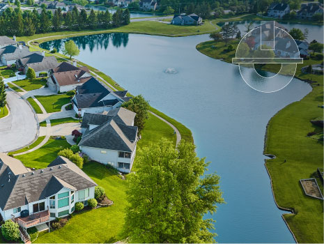 Aerial shot of houses next to large retention pond separating neighborhoods