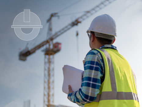 Civil Engineer consulting people on construction site holding blueprint in his hand and control workflow of the new building.