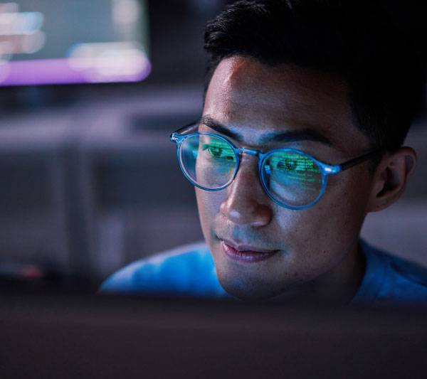 Businessman, computer or programming code in night at office for software development, cybersecurity or database safety.