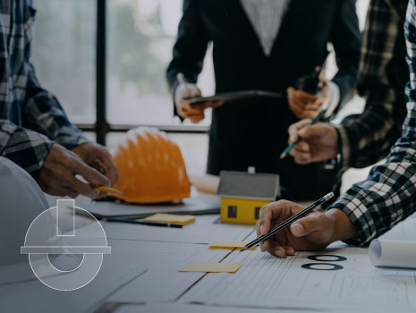 Working as a team architect, engineer and designer working on blueprint project of new apartments. Photo concept of work on technical drawings in office.