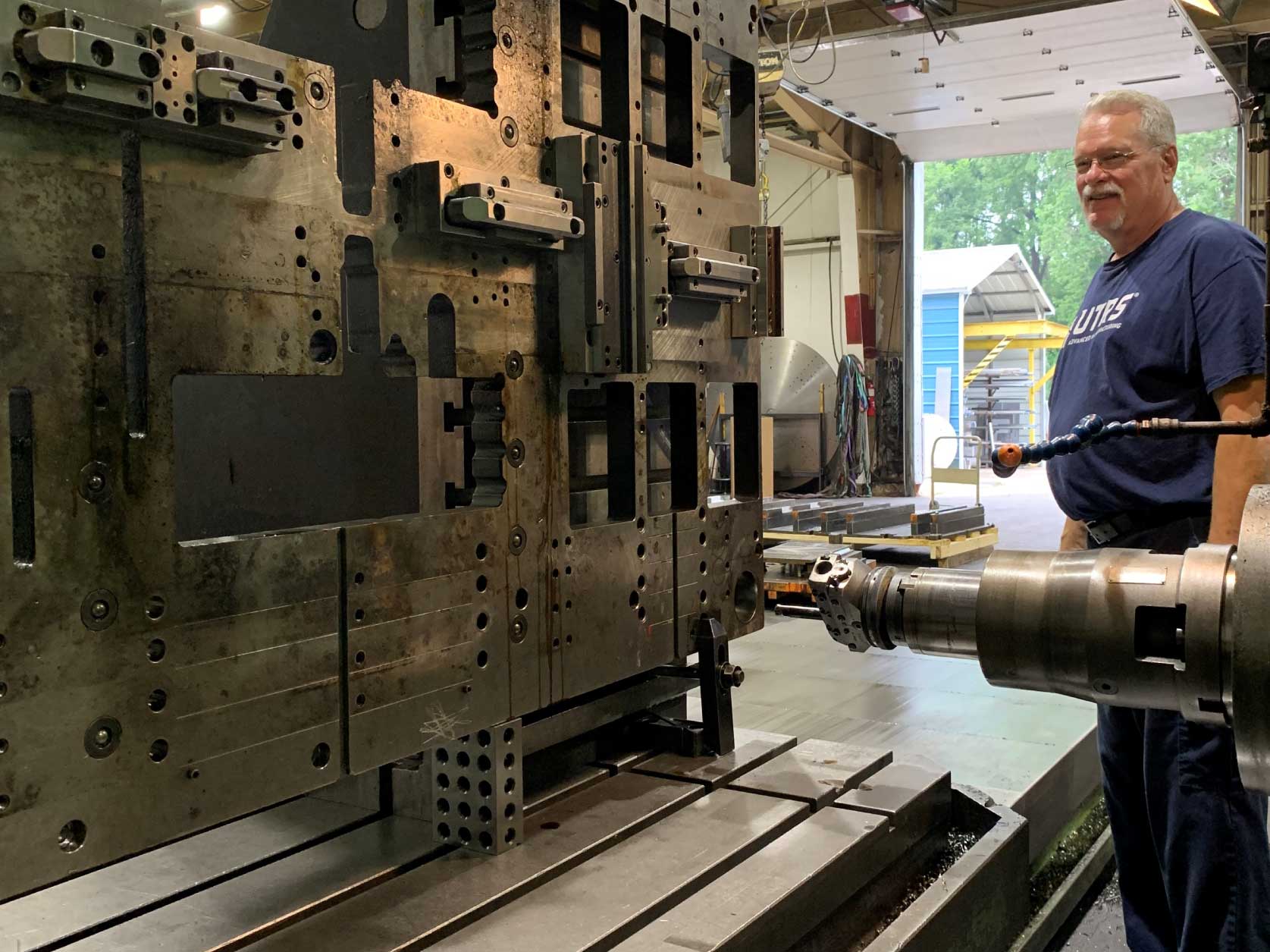 Preparing to repair a worn hole guide pin hole in a 4-ft wide by 8-ft long by 2-inches thick progress die set piece that weighs about 3,000 pounds.