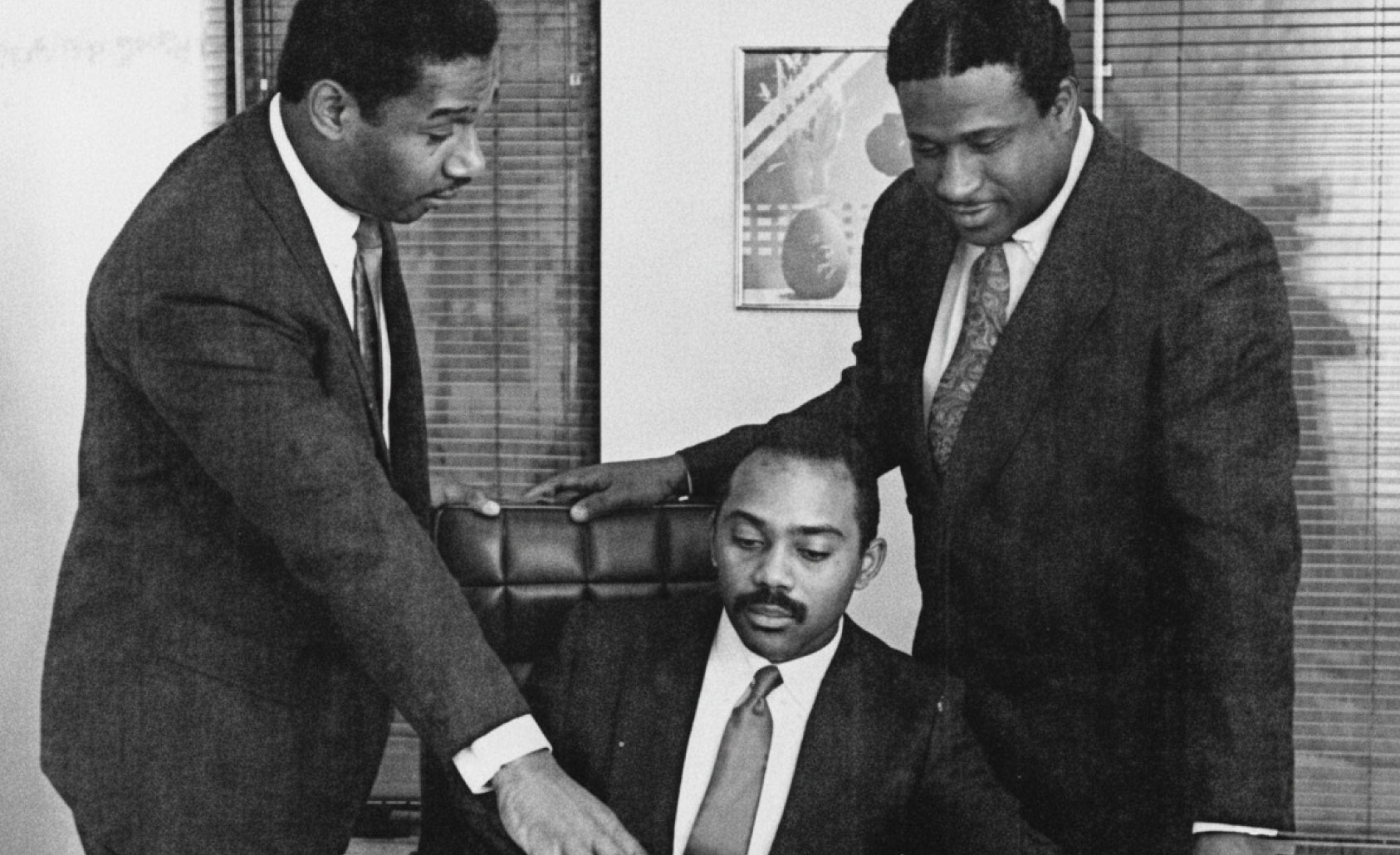 UTRS founders Lamont McLean (seated) and Gerry Wright (right), with Lloyd Booker, UTRS VP of Technical Services, in 1987. Photograph enhanced with AI for optimal presentation