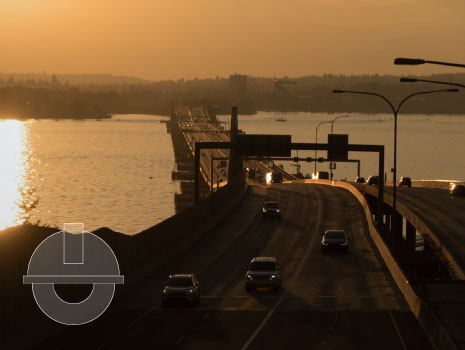 I-90 floating bridge at sunset over Lake Washington.