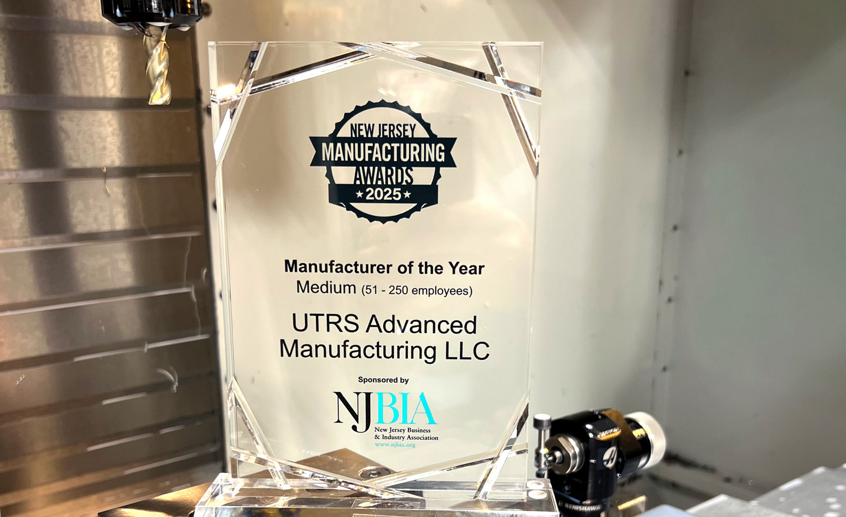 UTRS Advanced Manufacturing, LLC award for 2025 ‘MADE in New Jersey’ Manufacturing Day Manufacturer of the Year – MEDIUM award. Award is placed on manufacturing machine.
