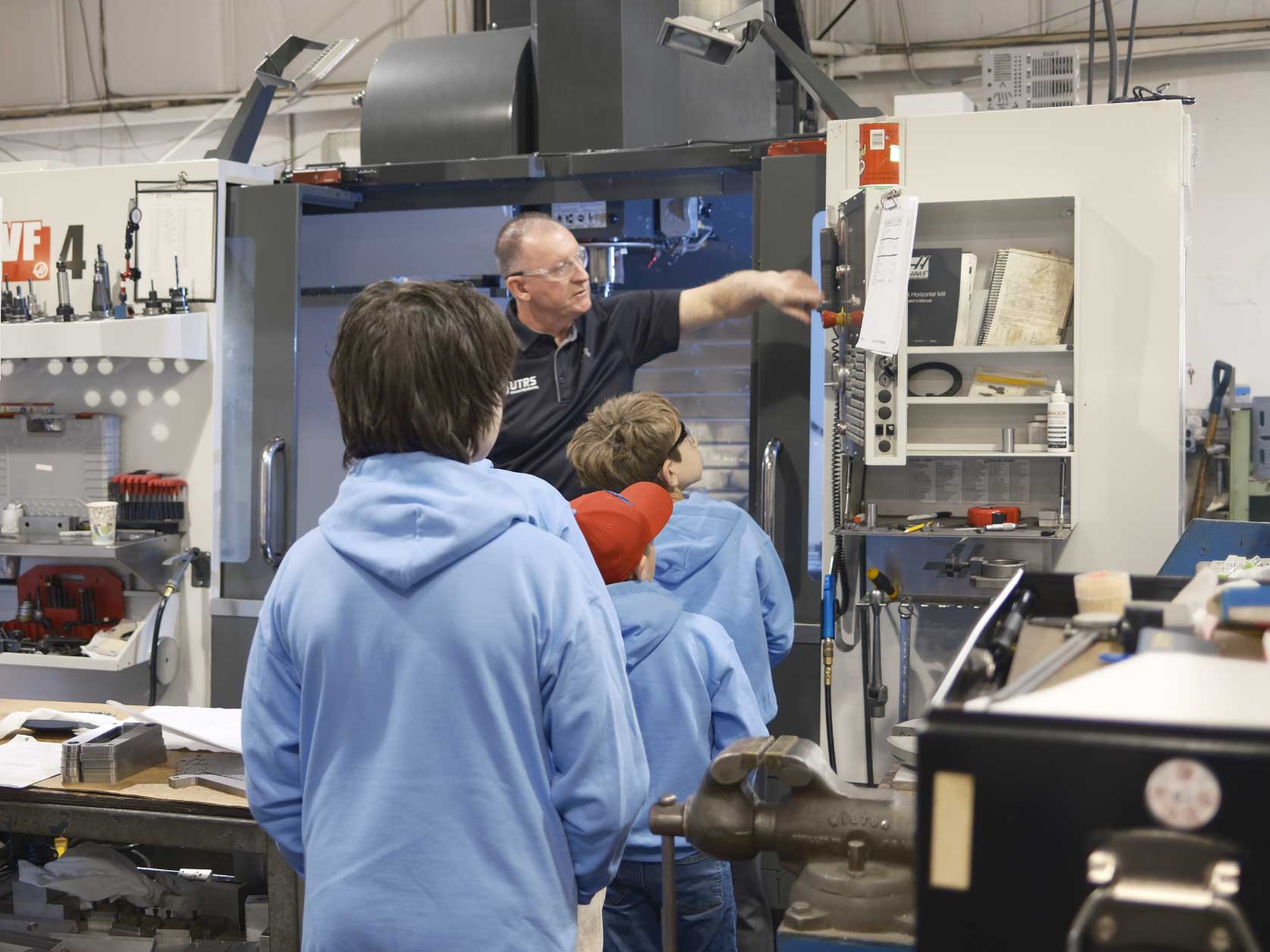 Children learning how CNC machines operate from UTRS Advanced Manufacturing’s Robbinsville Shop Supervisor.