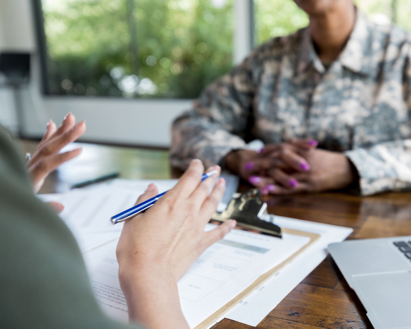 Female financial advisor talks with veteran