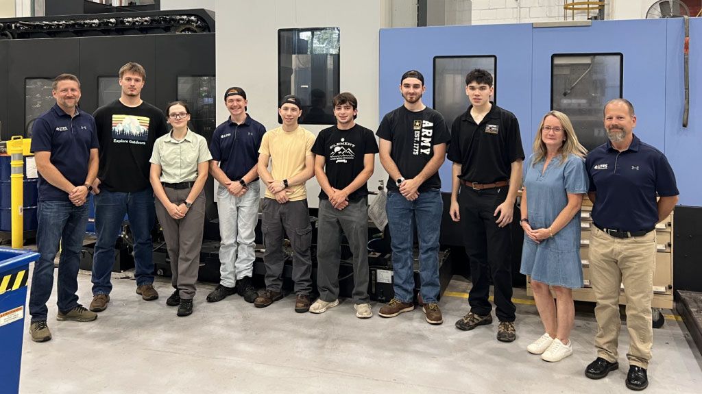 Group photo of current Universal Technical Resource Services, Inc. (UTRS) interns at facility at Picatinny Arsenal, along with some management