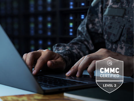 Soldier in camouflage uniform working on laptop for data security